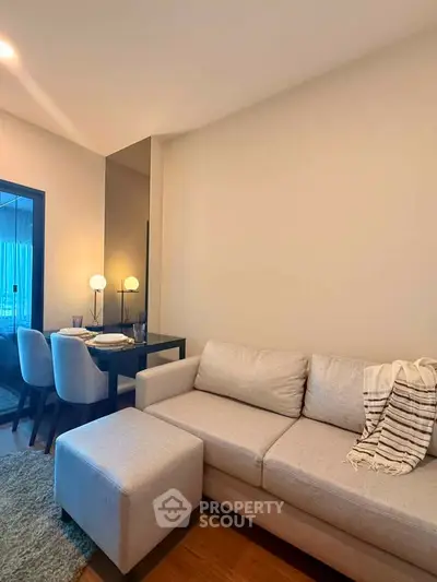 Cozy living room with modern sofa and dining area in stylish apartment