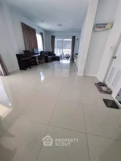 Spacious living room with modern decor and large windows for natural light.