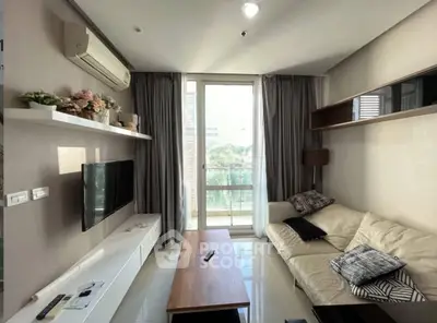 Modern living room with sleek design, large window, and stylish furniture in a contemporary apartment.