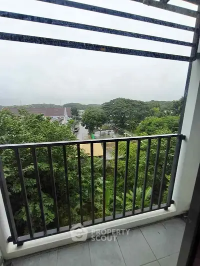 Charming balcony with lush green view, perfect for relaxation and enjoying nature.