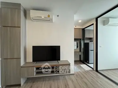 Modern living room with sleek TV stand and air conditioning in stylish apartment.