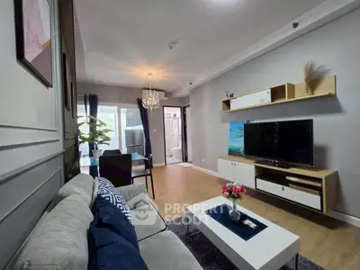 Modern living room with stylish decor and open layout, featuring a cozy sofa and elegant dining area.