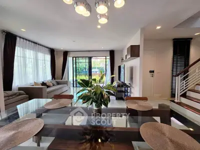 Spacious modern living room with elegant decor and large windows offering garden views.