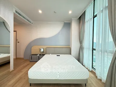Modern bedroom with large windows and stylish decor in a high-rise apartment.