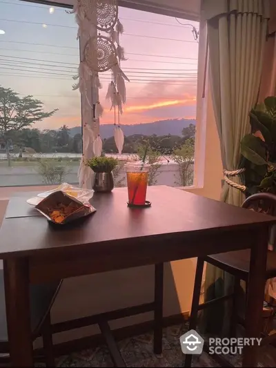 Cozy dining area with sunset view and stylish decor