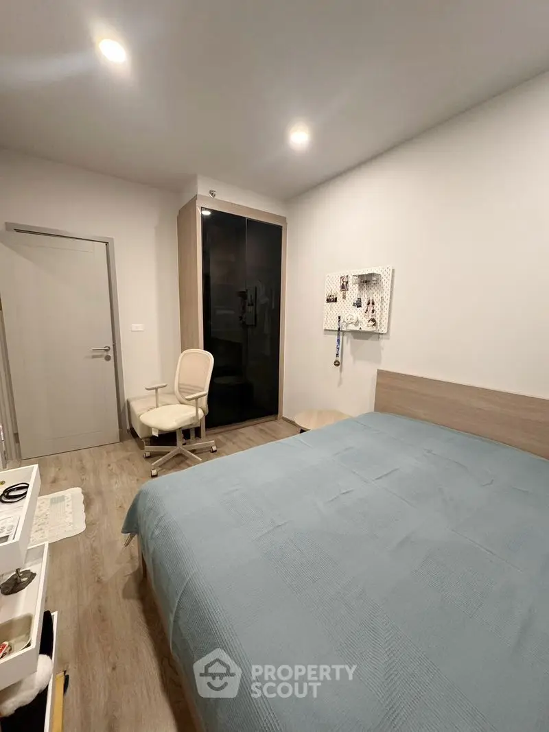 Modern bedroom with sleek wardrobe and cozy bed in minimalist design.
