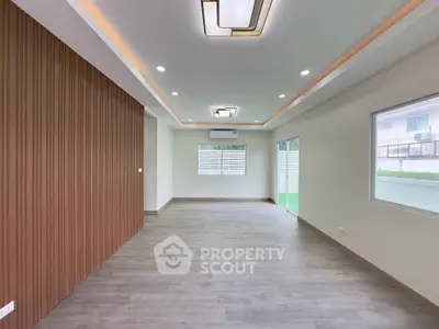 Spacious modern living room with elegant lighting and large windows for natural light.