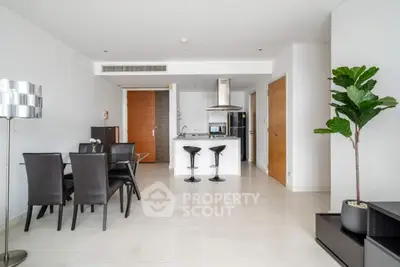 Modern open-plan living room with dining area and sleek kitchen design