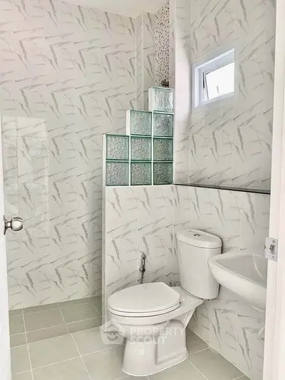 Modern bathroom with stylish tile design and compact layout