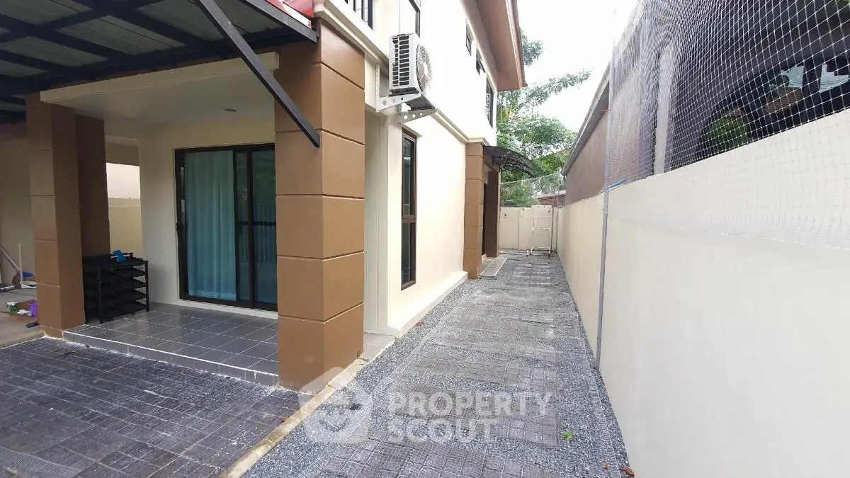 Modern house exterior with sleek design and spacious walkway, perfect for family living.