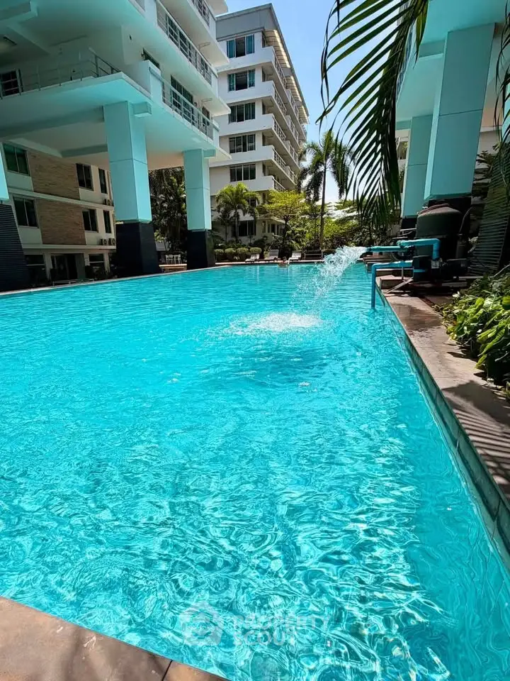 Luxurious apartment complex with a sparkling pool and modern architecture, perfect for relaxation and leisure.