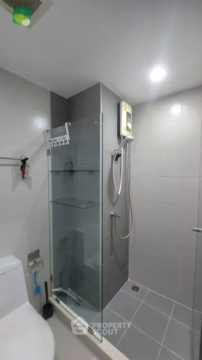 Modern bathroom with glass shower enclosure and sleek tile design