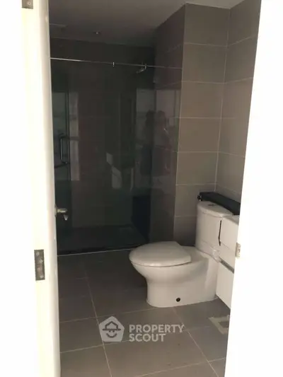 Modern bathroom with sleek design and glass shower enclosure.