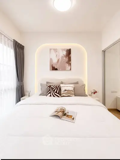 Modern bedroom with stylish decor and cozy bedding in a bright, well-lit space.