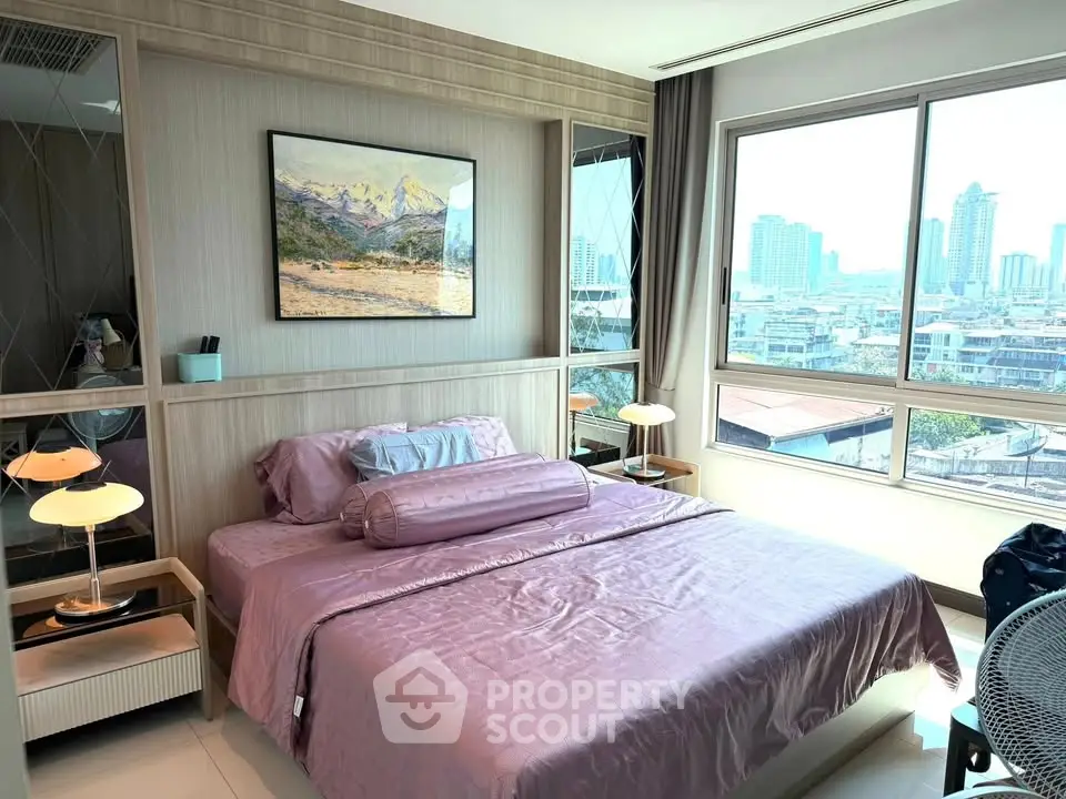 Modern bedroom with city view, featuring elegant decor and large windows for natural light.