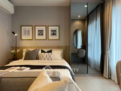 Elegant bedroom with modern decor, featuring a cozy bed, stylish mirror, and soft lighting for a serene ambiance.