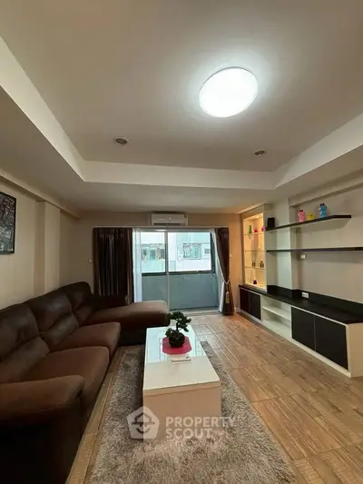 Spacious living room with modern decor and large sofa, perfect for relaxation.