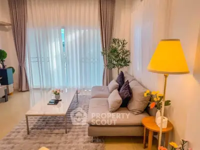 Chic living room with cozy sofa, elegant curtains, and stylish decor