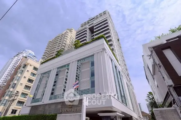 Stunning modern high-rise building with lush greenery and elegant architecture.