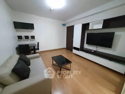 Modern living room with sleek furniture and wooden flooring in a stylish apartment.