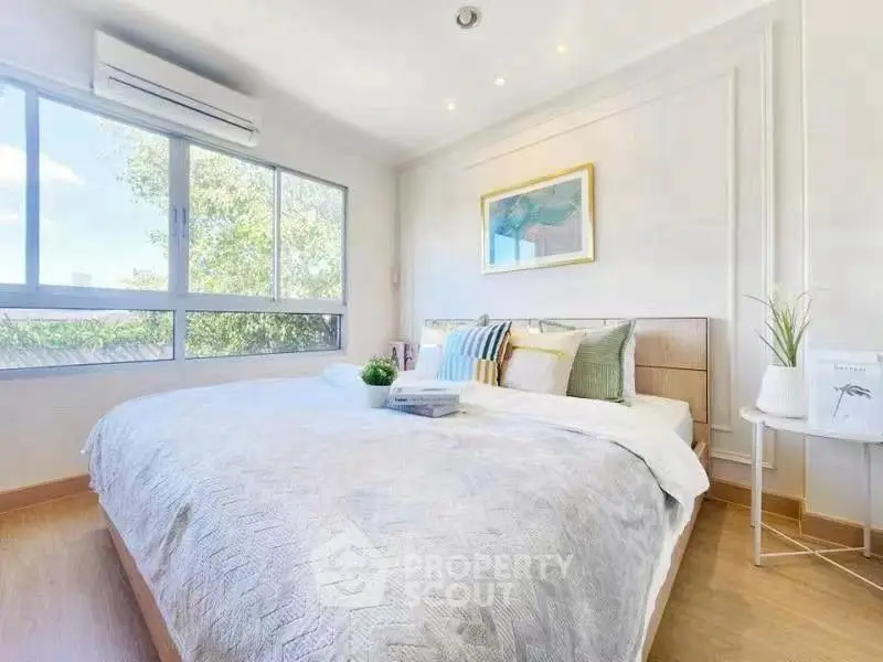 Bright and airy bedroom with large windows and modern decor