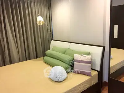 Cozy bedroom with modern decor and plush pillows, perfect for relaxation.