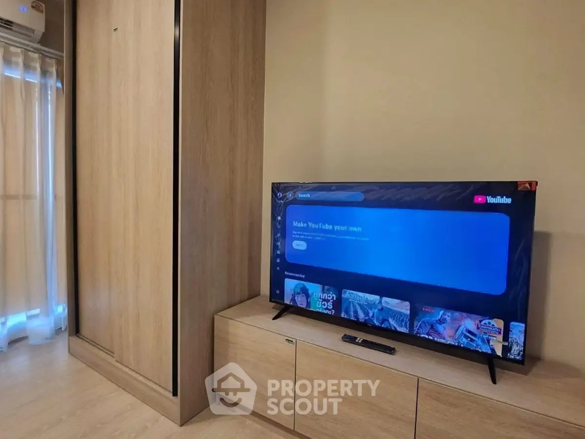 Modern living room with wooden furniture and flat-screen TV