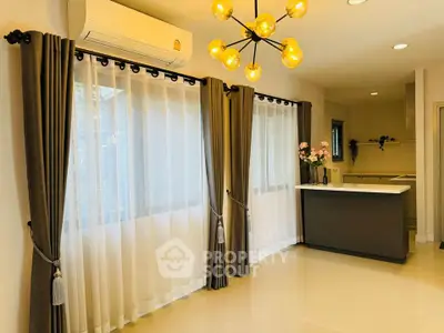 Modern kitchen with elegant lighting and large windows in a stylish home.
