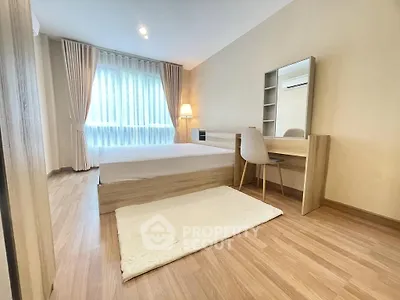 Spacious bedroom with modern decor and natural light