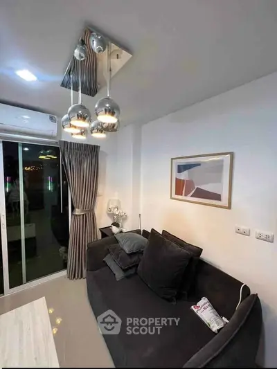 Modern living room with stylish pendant lights and cozy sofa in a chic apartment.