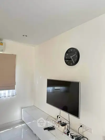 Modern living room with wall-mounted TV and minimalist decor