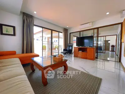 Spacious living room with modern furniture and large windows offering natural light
