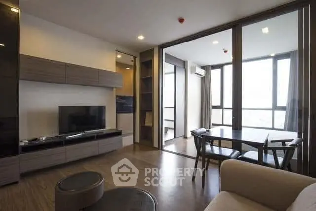 Modern living room with stylish furniture and large windows offering natural light.