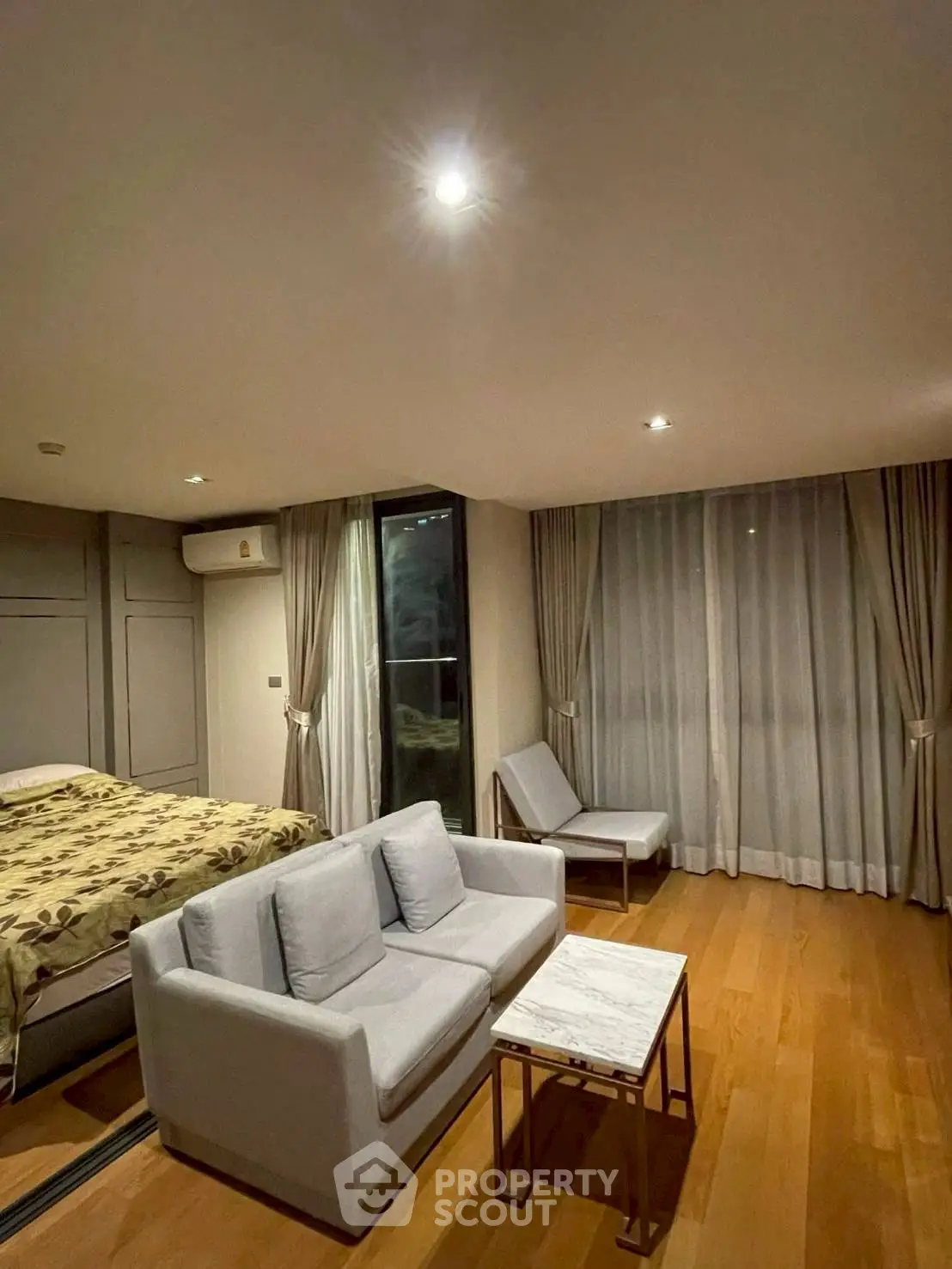 Modern bedroom with cozy seating area and elegant decor