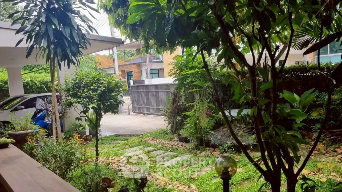 Charming garden view with lush greenery and modern architecture in a serene neighborhood.
