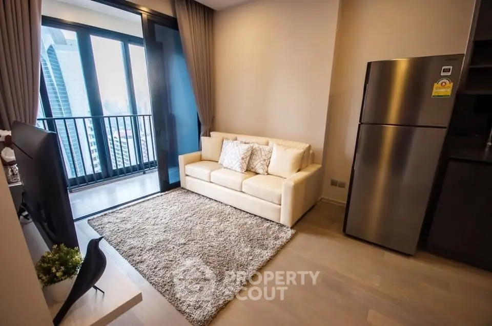 Modern living room with city view, cozy sofa, and sleek appliances in a high-rise apartment.