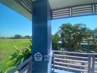 Charming balcony with lush garden view and vibrant blue accents