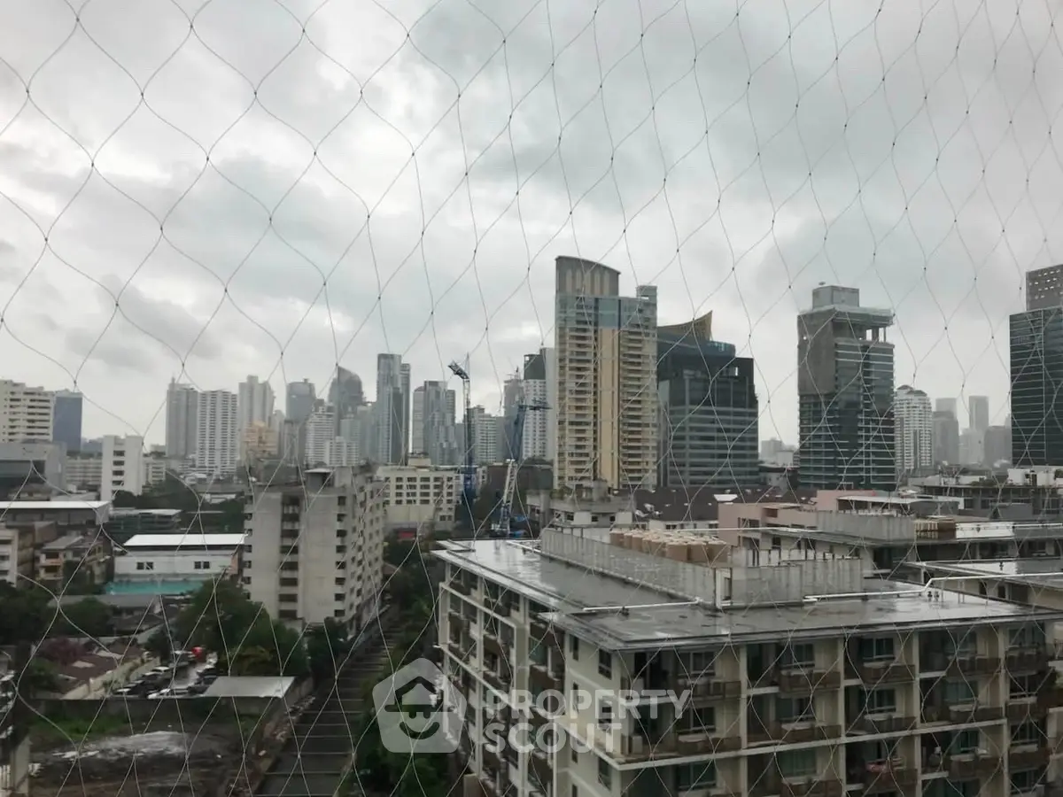 Stunning cityscape view from a high-rise building showcasing urban skyline and architecture.