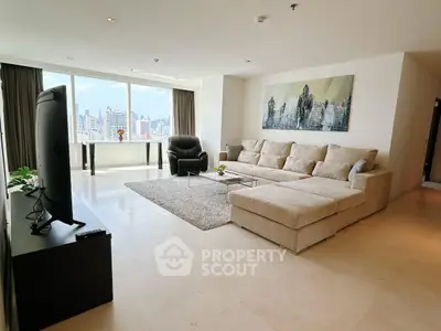 Spacious living room with city view, modern furniture, and large windows for natural light.