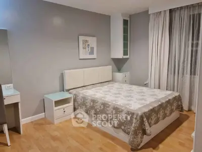 Spacious bedroom with elegant decor and natural light