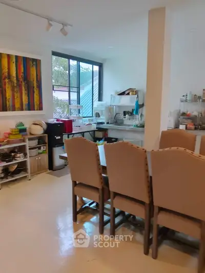 Spacious kitchen with dining area, modern decor, and ample natural light.