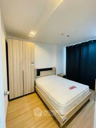 Modern bedroom with wooden flooring and sleek furniture design