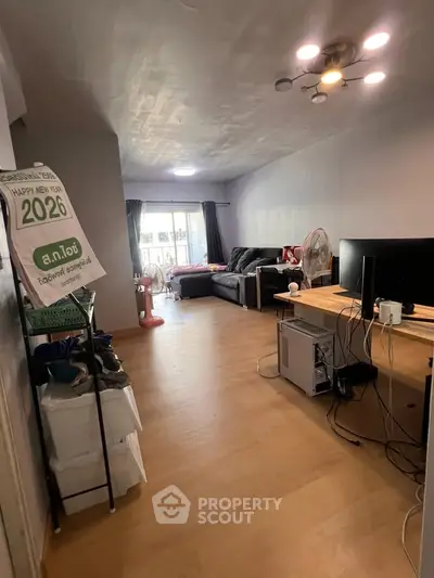 Spacious living room with modern decor and natural light, perfect for relaxation and entertainment.