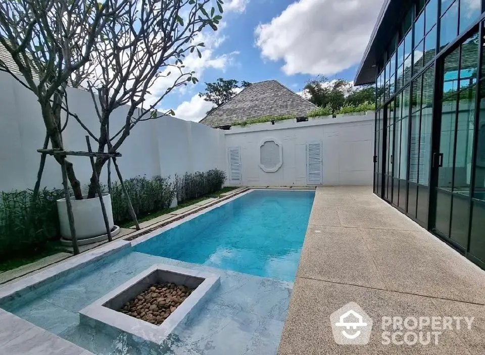 Luxurious private pool area with modern design and lush greenery