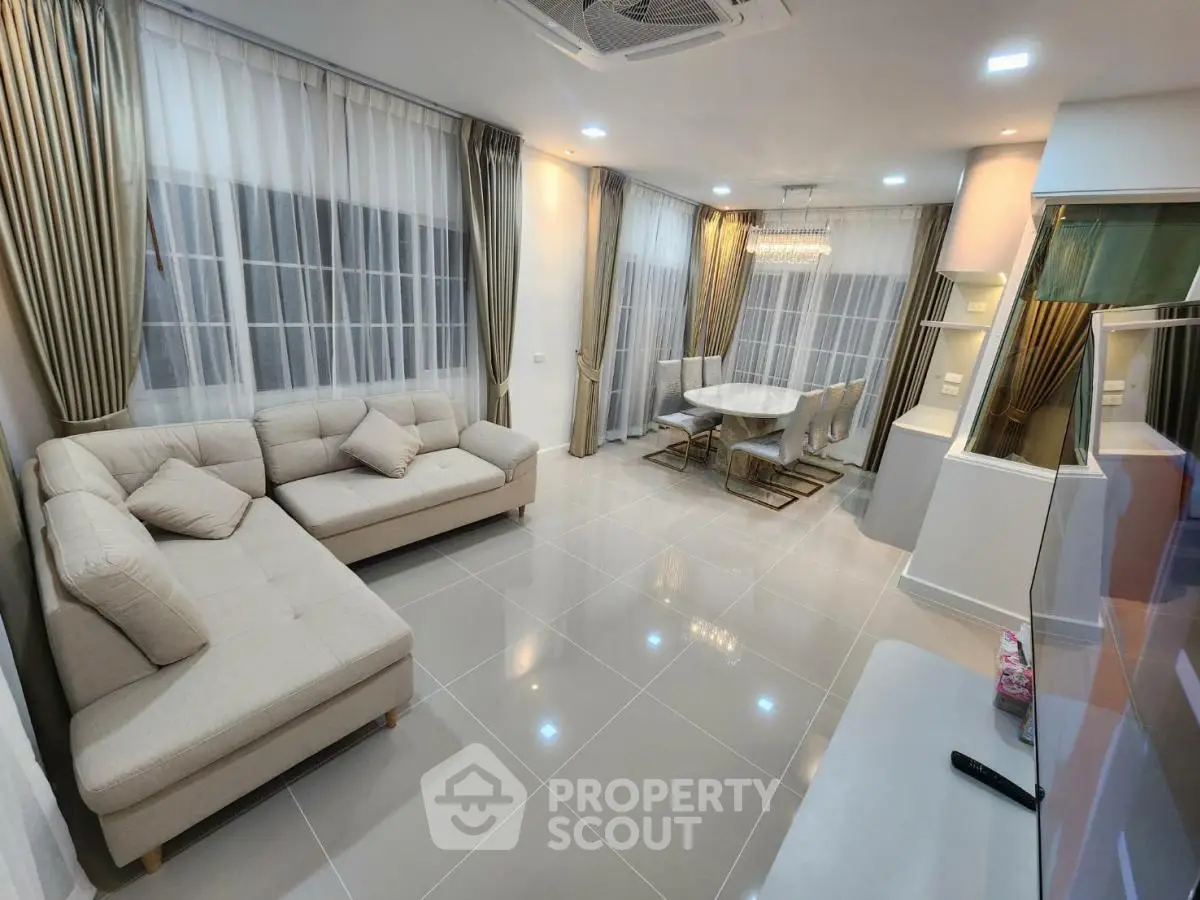 Spacious modern living room with elegant dining area and large windows