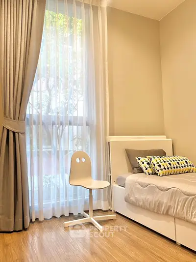 Modern bedroom with stylish decor and natural light