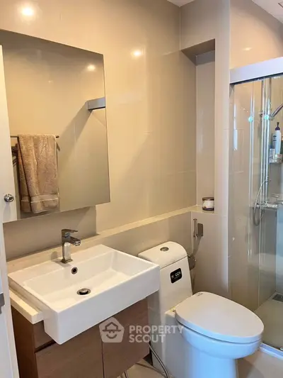Modern bathroom with sleek fixtures and glass shower enclosure