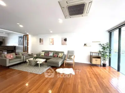 Spacious modern living room with hardwood floors and stylish decor
