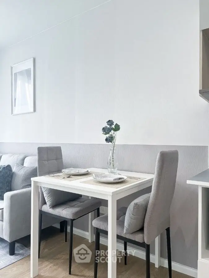 Modern dining nook with elegant decor and cozy seating in a stylish apartment.