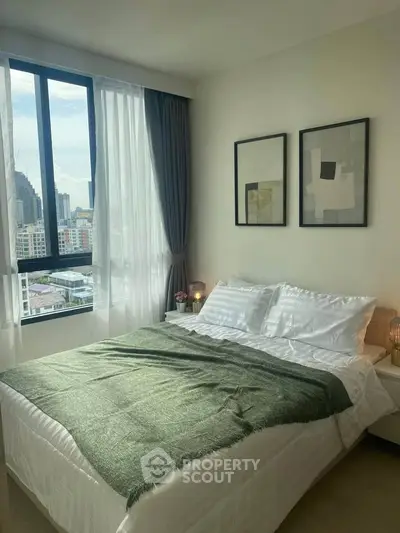 Cozy bedroom with city view, modern decor, and natural light.